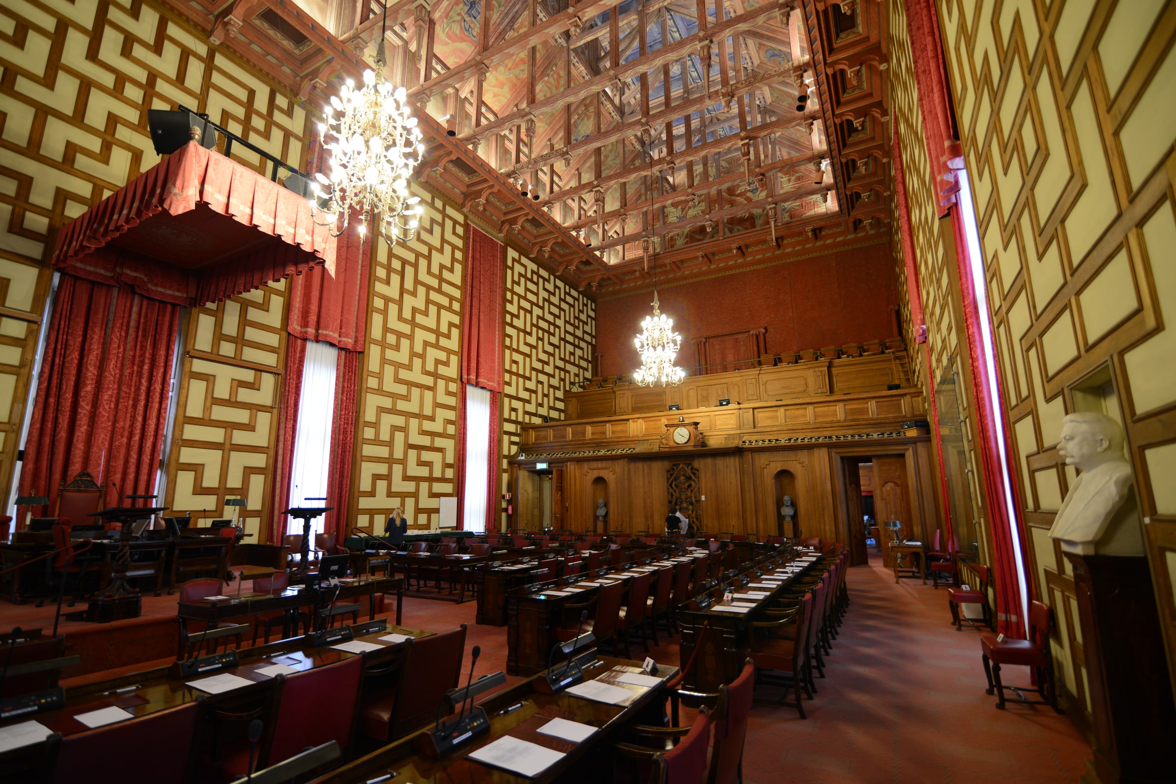 Rows of council desks, microphones and voting controls in Stockholm City Hall’s council chamber.